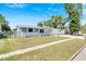 Front view of the charming house with a well-maintained lawn at 4923 Alcea St, New Port Richey, FL 34652