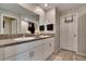 Double vanity bathroom with granite countertop and walk-in closet at 12958 Wildflower Meadow Dr, Riverview, FL 33579