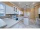 Bright kitchen featuring white cabinets, ample counter space, and tile floors at 10071 Georgetown Ct, Weeki Wachee, FL 34613