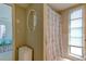 Bathroom featuring a tub with a shower curtain and an entrance to the bedroom at 1745 Harbor W Cir, Largo, FL 33770