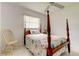 Bedroom with a four-poster bed, a ceiling fan, and a chair at 1745 Harbor W Cir, Largo, FL 33770