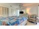 Cozy bedroom with a colorful quilt, white furnishings, and a comfortable armchair at 1745 Harbor W Cir, Largo, FL 33770