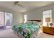 Bright bedroom with a ceiling fan, light walls, and sliding glass doors to the outside patio at 1745 Harbor W Cir, Largo, FL 33770