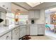 Bright kitchen with stainless steel sink, white dishwasher, and updated countertops at 1745 Harbor W Cir, Largo, FL 33770