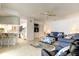 Open living room with a partial kitchen view, ceiling fan, and comfortable seating at 1745 Harbor W Cir, Largo, FL 33770