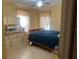 Bedroom with light yellow walls, tile flooring, and view into the hallway at 2011 Green Juniper Ln, Brandon, FL 33511