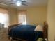 Cozy bedroom featuring yellow walls, a ceiling fan, and tiled flooring at 2011 Green Juniper Ln, Brandon, FL 33511