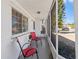 Inviting front porch with red chairs and screened enclosure at 3247 Kimberly Oaks Dr, Holiday, FL 34691