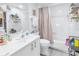 Bathroom with white vanity, bathtub, and pink shower curtain at 4780 Dolphin Cay S Ln # 501, St Petersburg, FL 33711