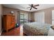 Bright bedroom with hardwood floors, fan, and a sliding glass door to the screened in patio at 5313 Bayshore Blvd # 5313, Tampa, FL 33611