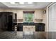 Kitchen featuring granite countertops, black appliances, and ample storage space at 5313 Bayshore Blvd # 5313, Tampa, FL 33611