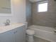 Updated bathroom with gray tile, white tub, and gray vanity at 6026 22Nd N Ave # 5, St Petersburg, FL 33710