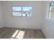 Bright bedroom with light gray wood-look flooring and large window at 6026 22Nd N Ave # 5, St Petersburg, FL 33710