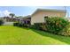 Large backyard with green lawn, lush landscaping, and fence at 1745 Harbor W Cir, Largo, FL 33770