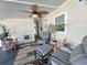 Bright screened porch with ceiling fan, seating, and plants at 13225 101St St # 454, Largo, FL 33773