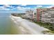 Aerial view of beachfront property with a pristine beach, luxurious high-rise buildings, and a refreshing pool at 17920 Gulf Blvd # 205, Redington Shores, FL 33708