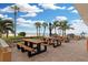 Outdoor patio with picnic tables and ocean view at 17920 Gulf Blvd # 205, Redington Shores, FL 33708
