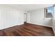 Spacious bedroom with hardwood floors and white closet doors at 17920 Gulf Blvd # 205, Redington Shores, FL 33708