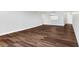 Spacious living room with dark brown wood-look flooring and kitchen pass-through at 17920 Gulf Blvd # 205, Redington Shores, FL 33708