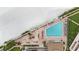 Resort-style beachfront pool with ample lounge chairs, umbrellas, and stunning ocean views at 17920 Gulf Blvd # 205, Redington Shores, FL 33708