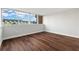 Bright bedroom with large window and wood-look floors at 17920 Gulf Blvd # 205, Redington Shores, FL 33708