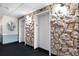 Hallway with elevators and stone accents at 17920 Gulf Blvd # 205, Redington Shores, FL 33708