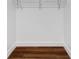 Walk-in closet with wire shelving and dark wood floor at 17920 Gulf Blvd # 205, Redington Shores, FL 33708