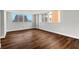 Well-lit bedroom with dark brown wood-look flooring and a view at 17920 Gulf Blvd # 205, Redington Shores, FL 33708