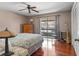 Bright bedroom with hardwood floors, a ceiling fan, and access to balcony at 5313 Bayshore Blvd # 5313, Tampa, FL 33611