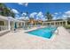 Inviting community pool with lounge chairs and brick pavers at 4780 Dolphin Cay S Ln # 501, St Petersburg, FL 33711