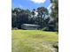 Mobile home with a large yard and covered structure at 6812 Woodsman Dr, Wesley Chapel, FL 33544