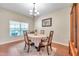 Bright dining room features a table with four chairs and a large window at 10833 Breaking Rocks Dr, Tampa, FL 33647