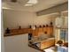 Upper-level view of the kitchen and dining area with light oak cabinetry and bright windows at 1873 Mazo Mnr # T2, Lutz, FL 33558