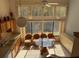 Bright eat-in kitchen with large windows, oak cabinets, and a glass-top table at 1873 Mazo Mnr # T2, Lutz, FL 33558