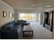 Bright living room featuring comfortable seating, a ceiling fan, and water views at 1873 Mazo Mnr # T2, Lutz, FL 33558