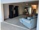 View of a cozy living room with a fan, display cabinet, and open staircase at 1873 Mazo Mnr # T2, Lutz, FL 33558