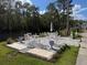 Outdoor patio area overlooking the water with white furniture and decorative flower pots at 1873 Mazo Mnr # T2, Lutz, FL 33558