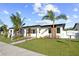 Modern house exterior, landscaped yard, palm trees, and walkway at 527 49Th N Ave, St Petersburg, FL 33703