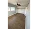 Bright bedroom features wood-look floors, a ceiling fan, and an open closet with shelves for storage at 6000 2Nd E St # 6, St Pete Beach, FL 33706