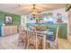 Bright dining room with a glass-top table and wicker chairs at 900 Gulf Blvd # 205, Indian Rocks Beach, FL 33785