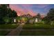 Elegant two-story home with stone accents, landscaping, and a paved walkway at dusk at 918 Shoals Landing Dr, Brandon, FL 33511