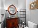 Stylish bathroom with ornate vanity and a round mirror at 918 Shoals Landing Dr, Brandon, FL 33511