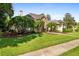 Two-story house with stone accents, palm trees, and manicured lawn at 918 Shoals Landing Dr, Brandon, FL 33511
