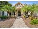 Inviting front entry with stone accents and palm trees at 918 Shoals Landing Dr, Brandon, FL 33511