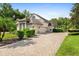 Three-car garage with paver driveway and lush landscaping at 918 Shoals Landing Dr, Brandon, FL 33511
