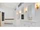 A bright bathroom features dual sinks, modern lighting, and a built-in tub for a luxurious experience at 1935 Lago Vista Blvd, Palm Harbor, FL 34685