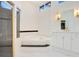 Well-lit bathroom showcasing a glass-enclosed shower, soaking tub, and double vanity, providing a spa-like retreat at 1935 Lago Vista Blvd, Palm Harbor, FL 34685