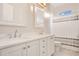 Bright bathroom featuring double sinks with marble countertops, framed mirrors, and modern fixtures at 1935 Lago Vista Blvd, Palm Harbor, FL 34685