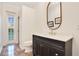 Bathroom with dark vanity, decorative mirror, and a door leading to the pool area, creating a luxurious and convenient space at 1935 Lago Vista Blvd, Palm Harbor, FL 34685