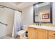 Bathroom featuring a shower, toilet, and vanity with a marble countertop and wooden cabinets at 1935 Lago Vista Blvd, Palm Harbor, FL 34685
